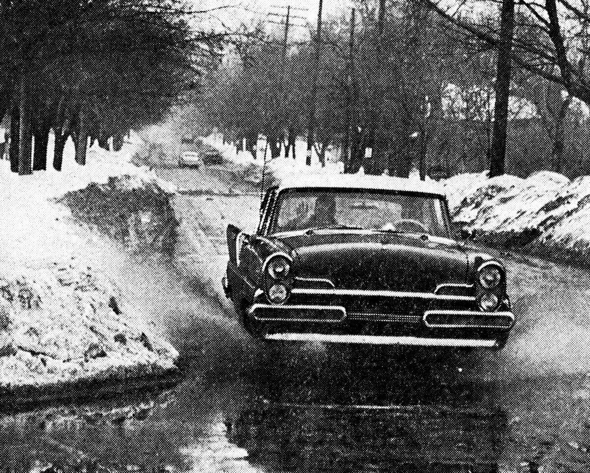 It wasn't the nicest day but it was the first real thaw this winter and a good deal of the snow has melted down the drain. With the 42 degree temperature yesterday, large amounts of water were found at many intersections. The photo was published in the News Advocate on Feb. 7 1963.