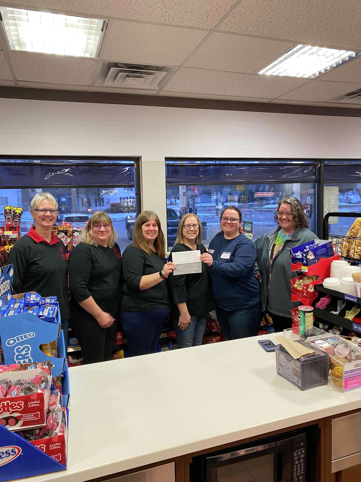 Members of the Reed City General Federtion of Women's Club accept a check for $14,431 from the Reed City WESCO. Funds were collected through community donations and the company.