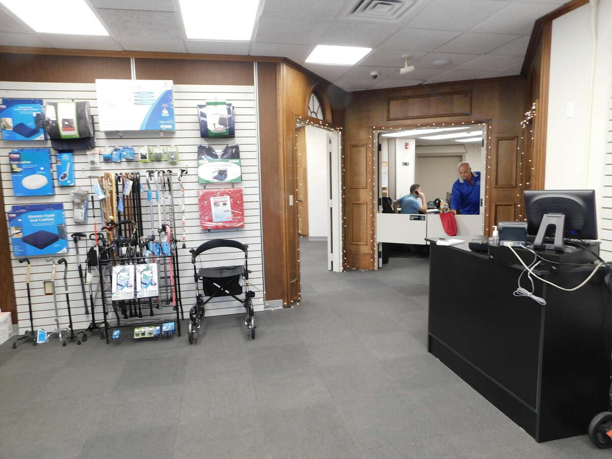 The entryway of Petricone's Medical Equipment at 100 E. Main St., with medical equipment coordinator Matt Zeiner (on phone) and owner Joseph Petricone Jr. in the office area.