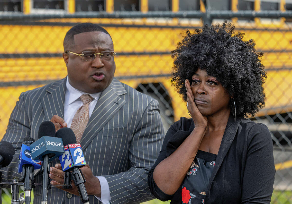 A mother whose 6-year-old was reportedly sexually abused on an Aldine ISD school bus cries as Quanell X talks to the media during a news conference on Feb. 6, 2023, at an Aldine ISD transportation hub in Houston.