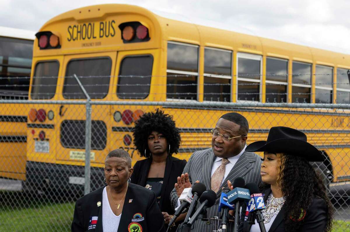 A mother whose six-year-old was sexually abused on an Aldine ISD school bus listens as Quanell X talks to the media during a press conference on February 6, 2023 at Aldine ISD Transportation In Houston, Texas.