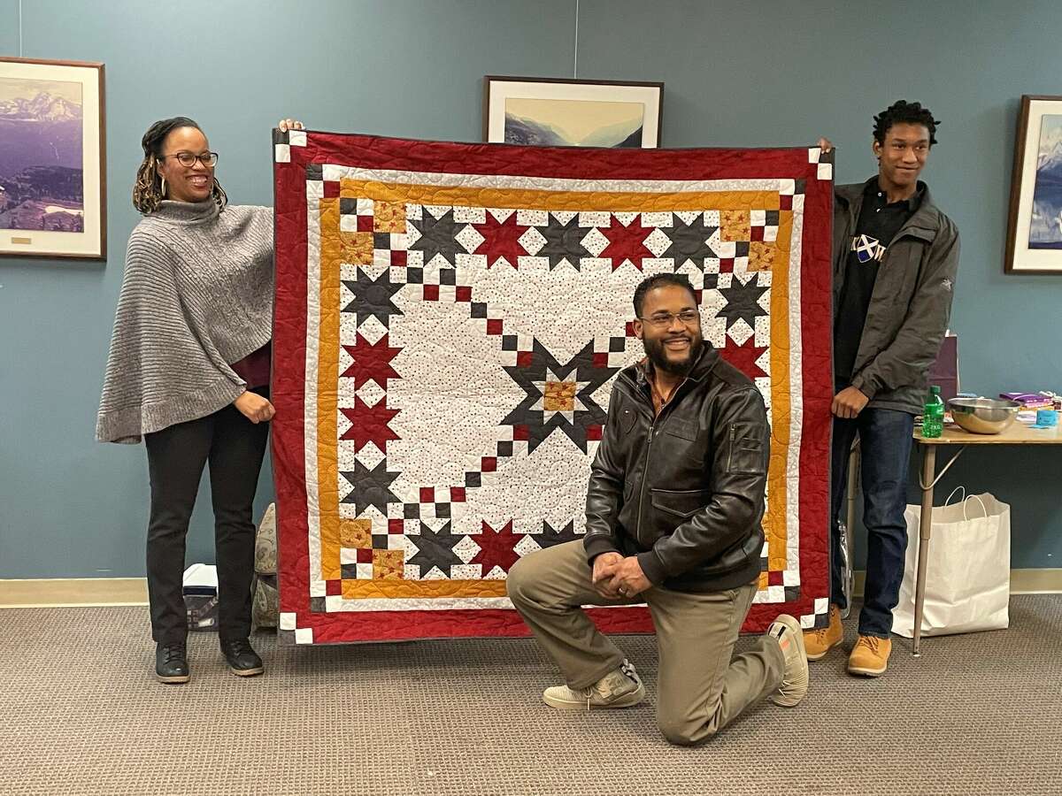 The Old Jail Quilters presented former Marine Lamont Belvin (center) a Quilt of Valor during their showcase for the Festival of the Arts.