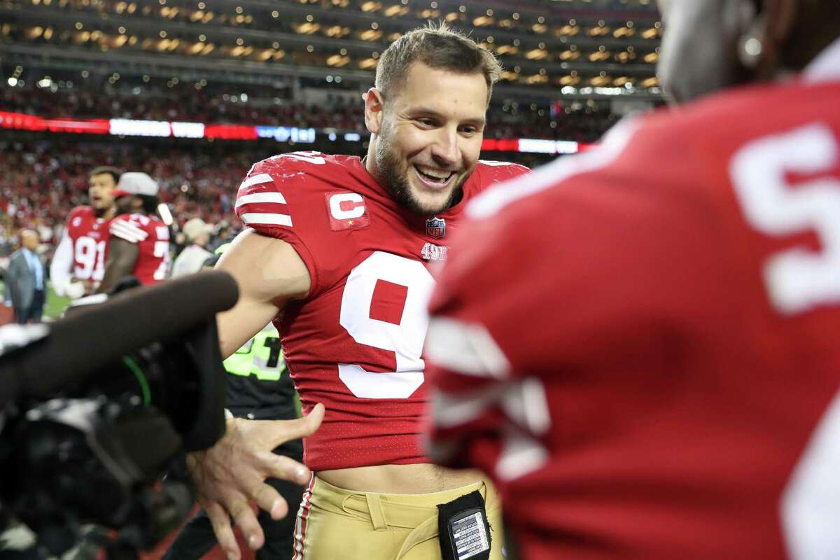 San Francisco 49ers’ Nick Bosa and Deebo Samuel celebrate after Niners’ 19-12 win over Dallas Cowboys during NFC Divisional Playoff game in Santa Clara, Calif., on Sunday, January 22, 2023.