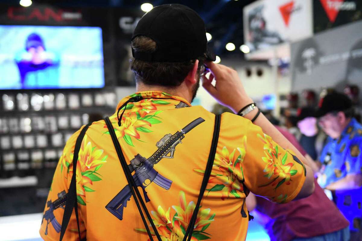 An attendee wears a shirt featuring an AR-15 style rifle during the National Rifle Association (NRA) Annual Meeting at the George R. Brown Convention Center, in Houston, Texas on May 28, 2022. (Patrick T. Fallon/AFP/Getty Images/TNS)