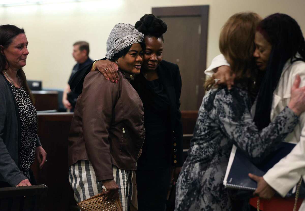 Hyacinth Maureen Smith (center), mother of Andreen McDonald, receives a hug after the sentencing of Andre McDonald on Monday. Convicted last week — but not of murder — Andre McDonald drew 20 years for manslaughter. He admitted he killed Andreen, his wife, in 2019.