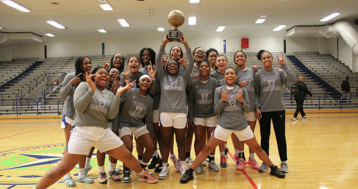 The Westside Lady Wolves celebrate their District 18-6A title with a 56-29 win over Sam Houston Monday night at the Butler Fieldhouse. It's the first district title for Westside since the 2018-2019 season.