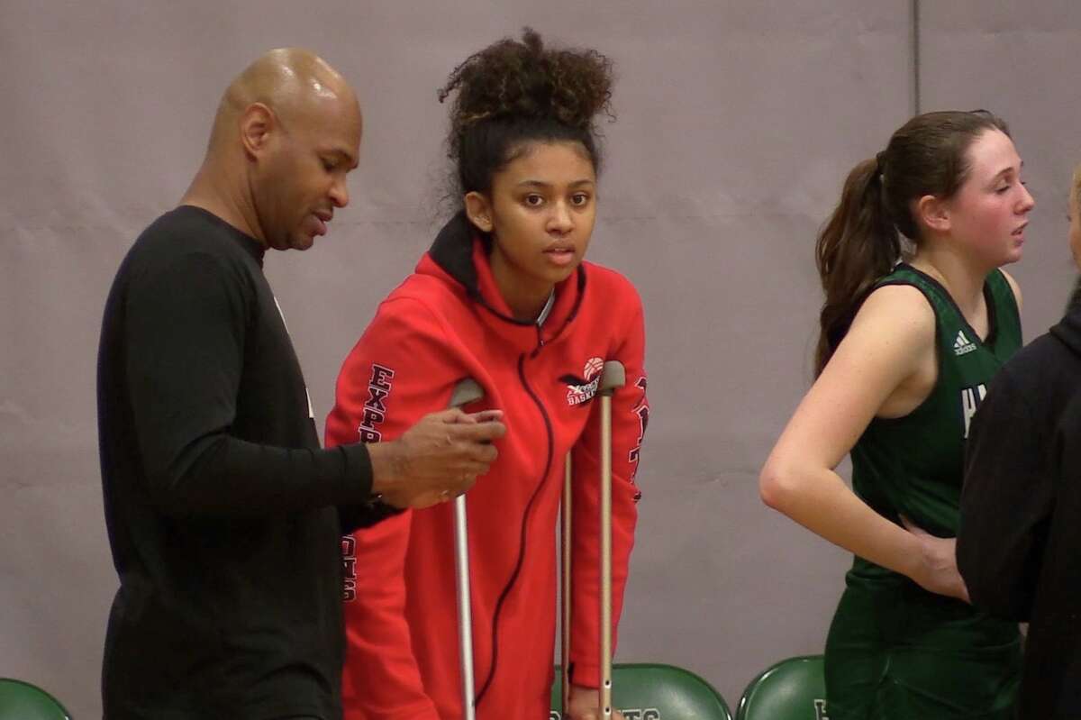 Hamden Hall's Jayda Johnson (center) with coach Brian Johnson during the Hornets'  60-48 loss to St. Luke's at the Beckerman Athletic Center Monday, Feb. 6, 2023. 
