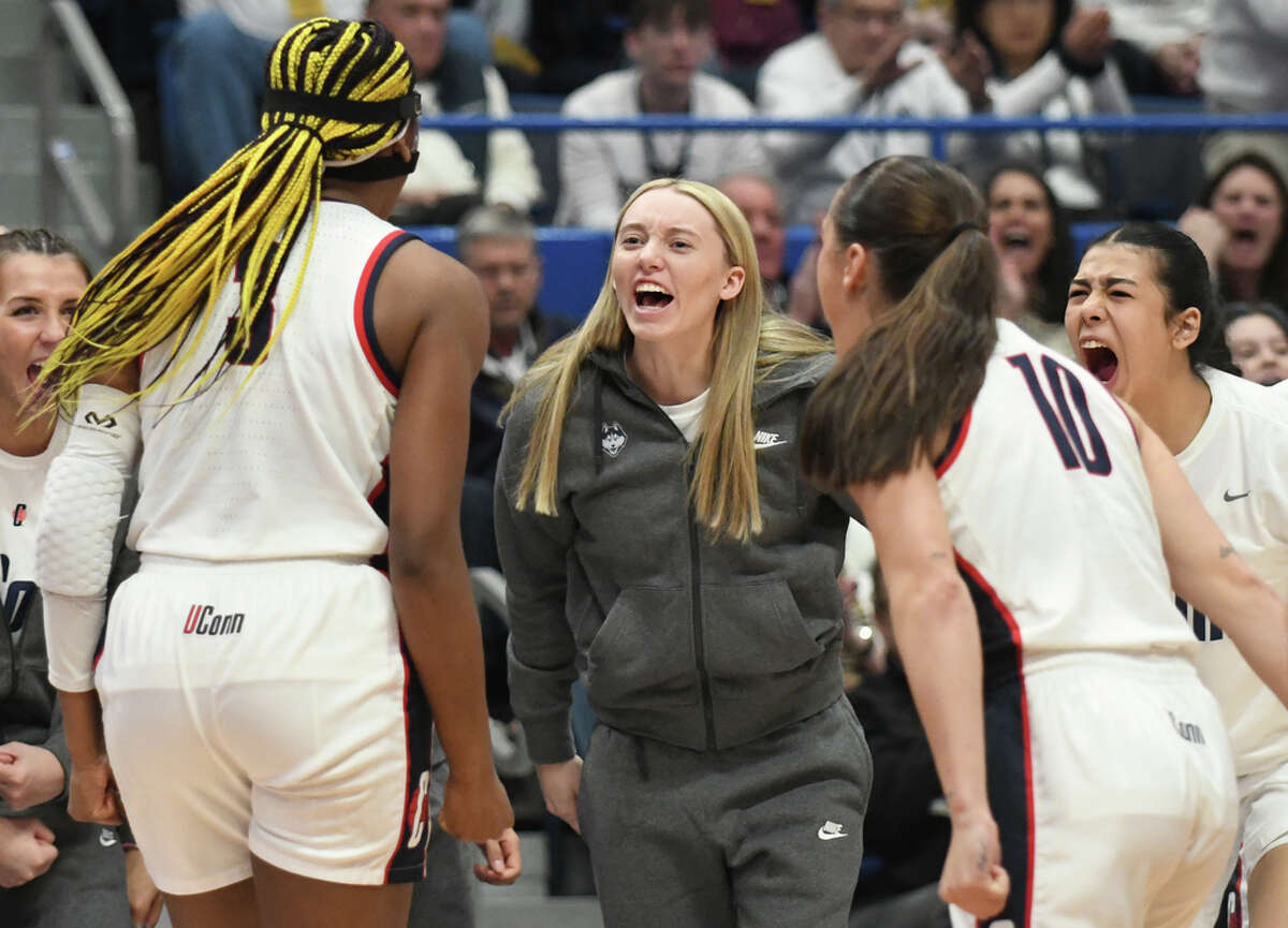Injured UConn guard Paige Bueckers cheers on her teammates during No. 1 South Carolina's 81-77 win over No. 5 UConn in the NCAA women's basketball game at the XL Center in Hartford, Conn. Sunday, Feb. 5, 2023.