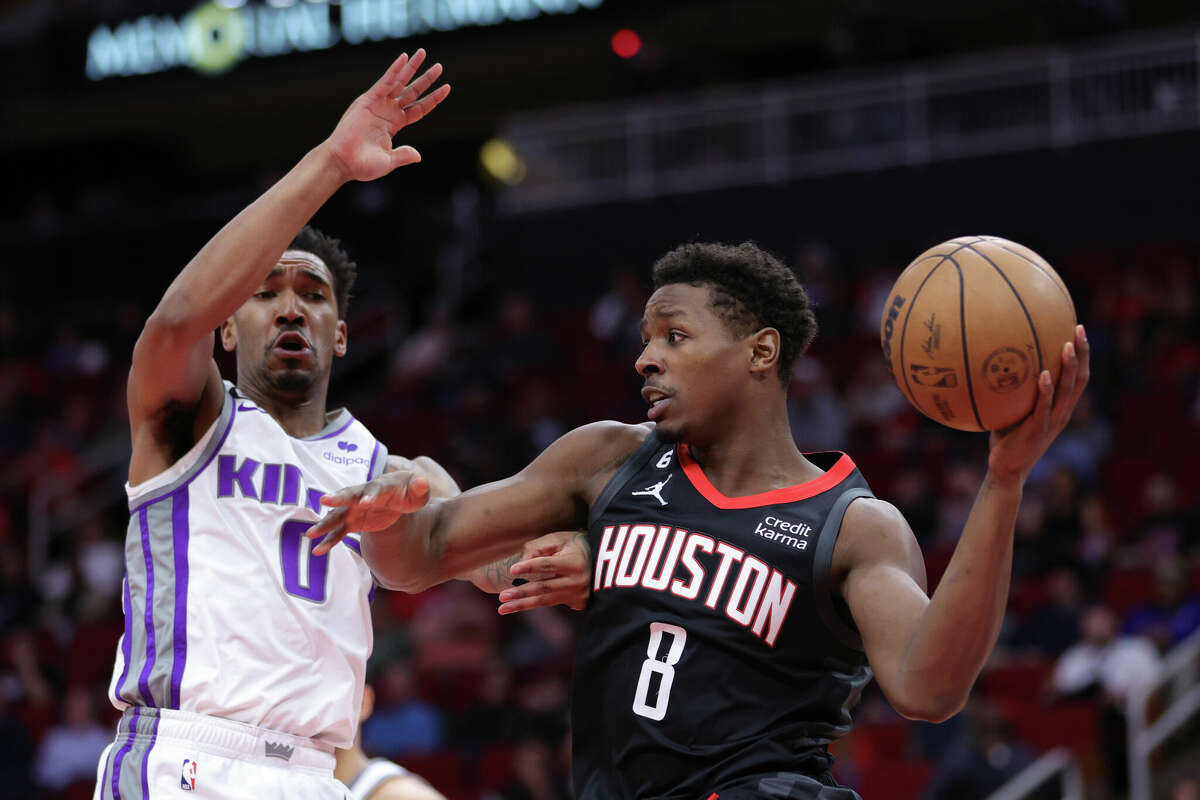 HOUSTON, TEXAS - FEBRUARY 06: Jae'Sean Tate #8 of the Houston Rockets drives against Malik Monk #0 of the Sacramento Kings during the first half at Toyota Center on February 06, 2023 in Houston, Texas. NOTE TO USER: User expressly acknowledges and agrees that, by downloading and or using this photograph, User is consenting to the terms and conditions of the Getty Images License Agreement. (Photo by Carmen Mandato/Getty Images)