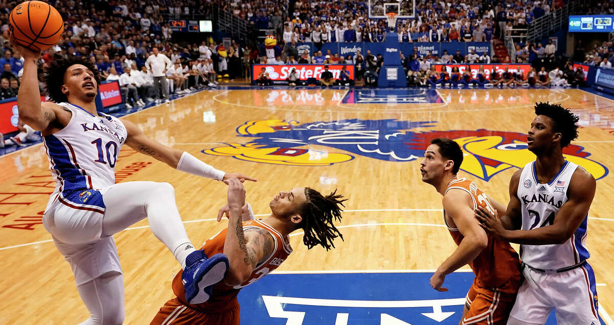 Kansas forward Jalen Wilson (10) shoots over Texas forward Christian Bishop (32) during the first half of an NCAA college basketball game Monday, Feb. 6, 2023, in Lawrence, Kan. (AP Photo/Charlie Riedel)