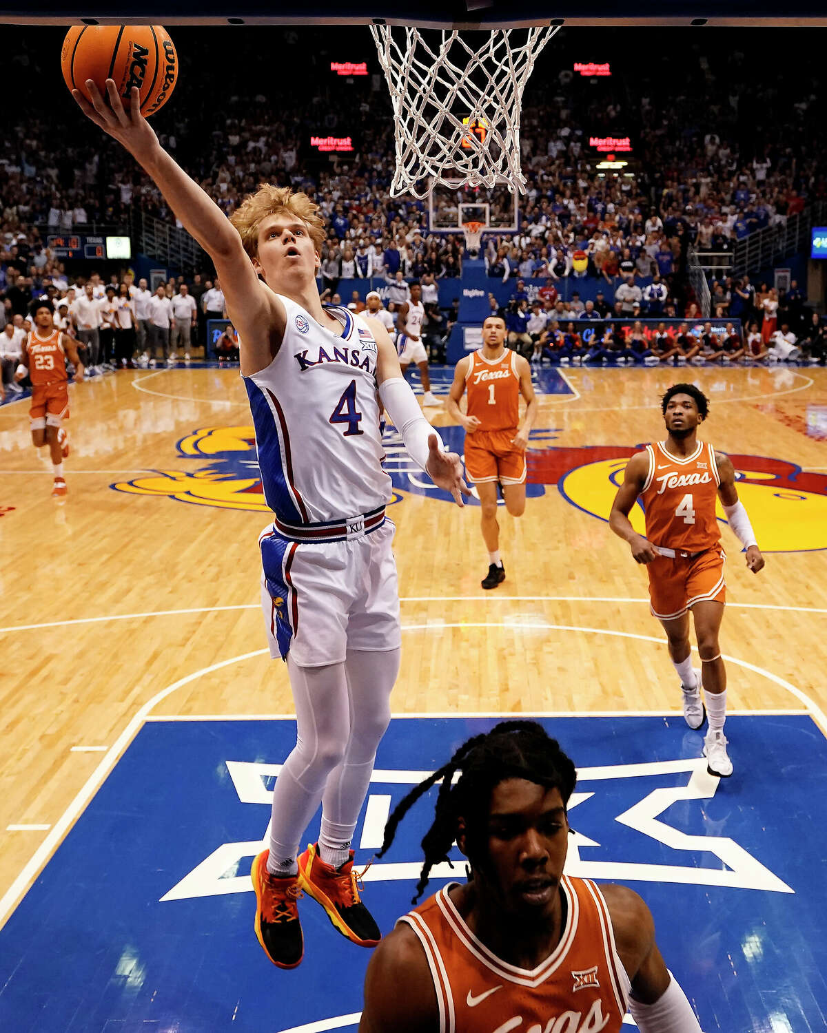 Kansas guard Gradey Dick (4) puts up a shot during the first half of an NCAA college basketball game against Texas Monday, Feb. 6, 2023, in Lawrence, Kan. (AP Photo/Charlie Riedel)