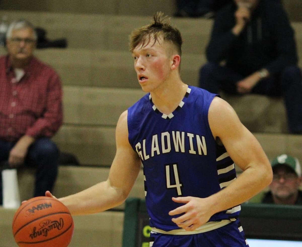Gladwin's Lucas Mead handles the ball during a game earlier this season. Mead had 18 points to lead the Flying G's over Mount Pleasant Sacred Heart in overtime on Monday.