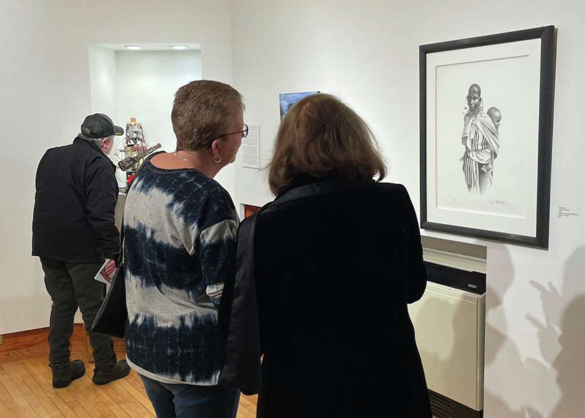The Ramsdell Theatre in Manistee held an opening reception Feb. 4 for its 'Journey of Discovery' exhibit. Attendees view the works of Paul Collins, one of three Idlewild artists included in the exhibit.