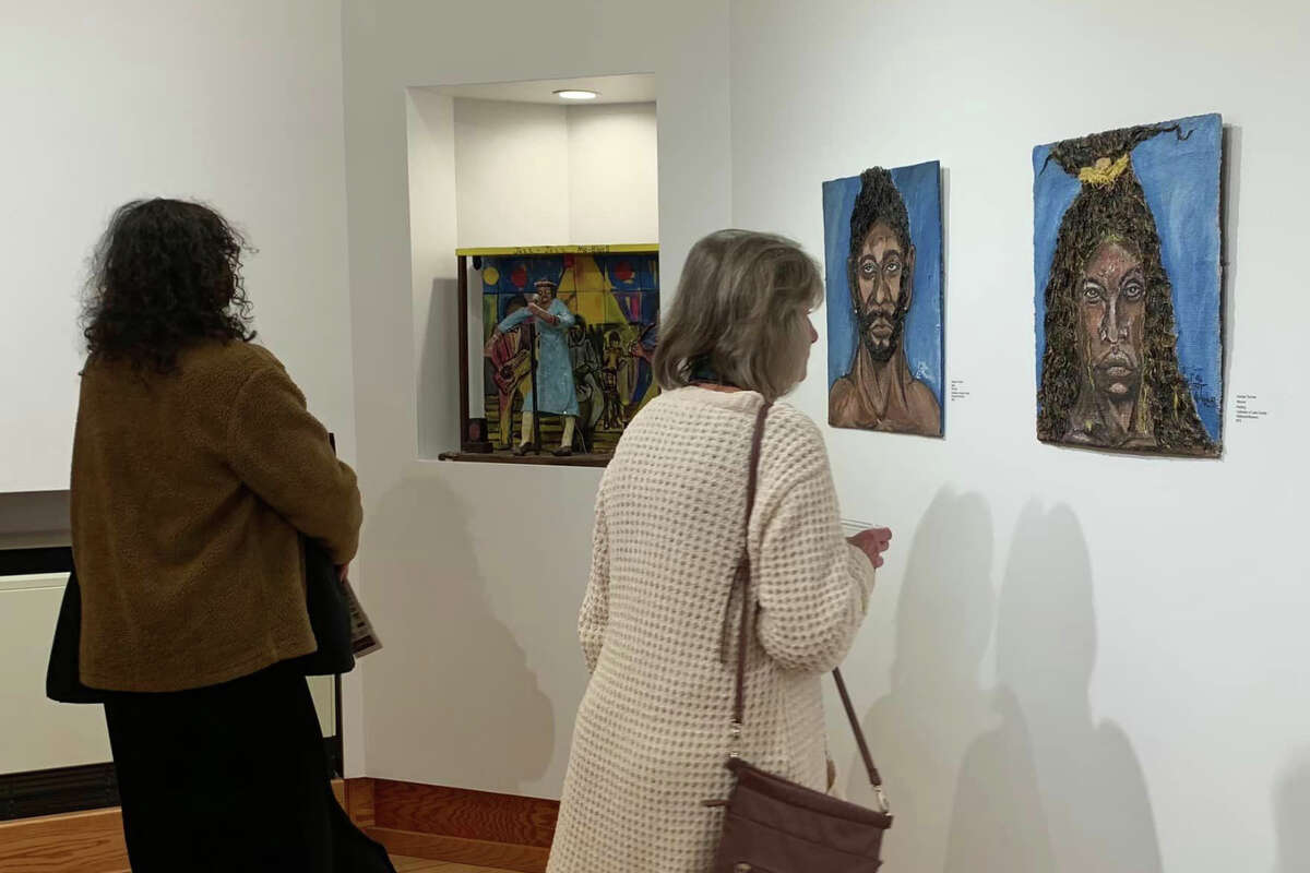 The Ramsdell Theatre in Manistee held an opening reception Feb. 4 for its 'Journey of Discovery' exhibit. Attendees view the works of George Thomas, one of three Idlewild artists included in the exhibit.