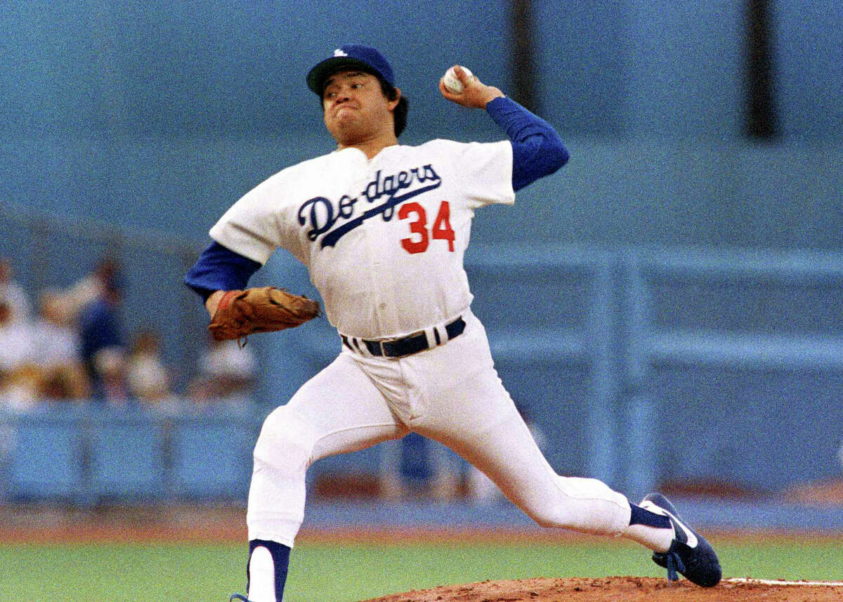 FILE - Los Angeles Dodgers pitcher Fernando Valenzuela prepares to release the ball in the first inning of the opening game of the National League Championship series against the St. Louis Cardinals, Oct. 9, 1985, in Los Angeles. The Dodgers will retire the No. 34 jersey of Valenzuela during a three-day celebration this summer. 