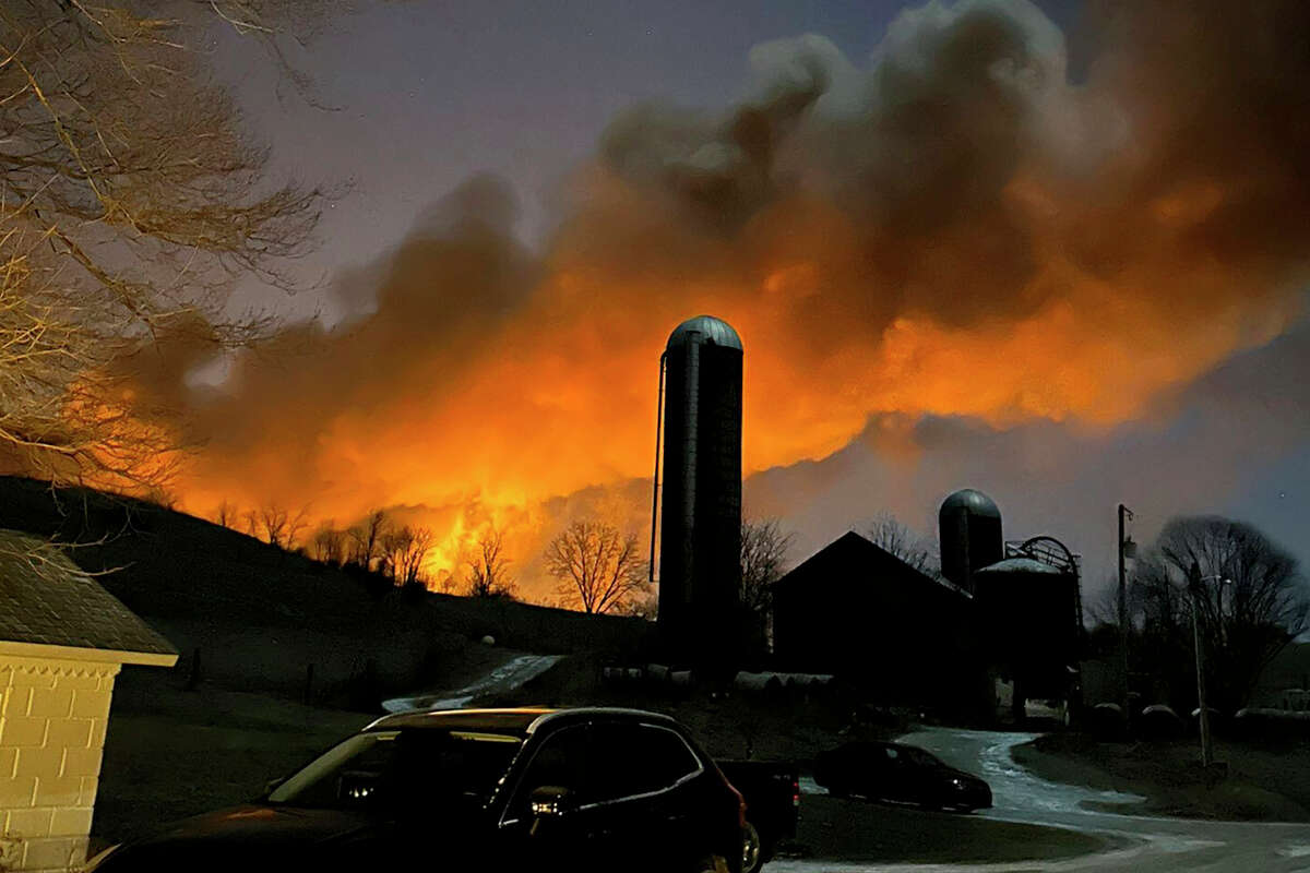 In this photo provided by Melissa Smith, a train fire is seen from her farm in East Palestine, Ohio, on Friday, Feb. 3.