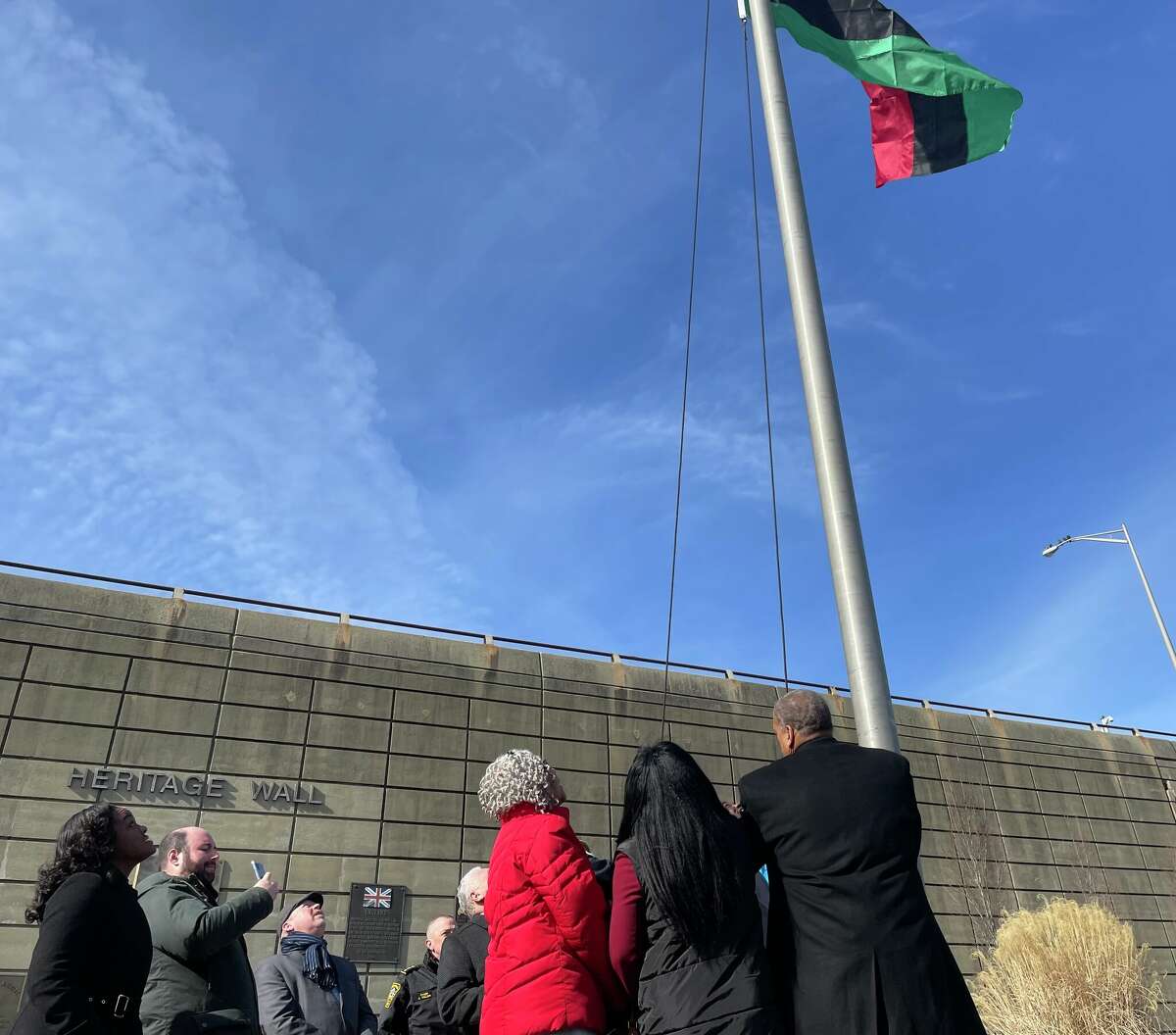 City and local officials gather at the Norwalk Heritage Wall to raise the Pan-African flag in honor of Black History Month on Feb. 7, 2023. 
