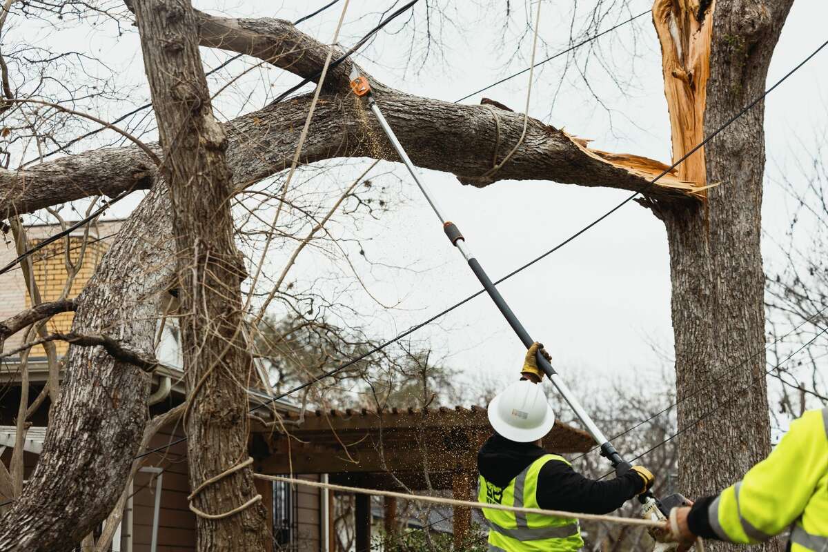 A lineman removes tree limbs that have fallen on power lines following a winter storm in Austin, Texas, US, on Friday, Feb 3, 2023. Across Texas more than 240, 000 were without power on Friday morning after an ice storm swept through the region on Monday, according to PowerOutage.us. Photographer: Jordan Vonderhaar/Bloomberg