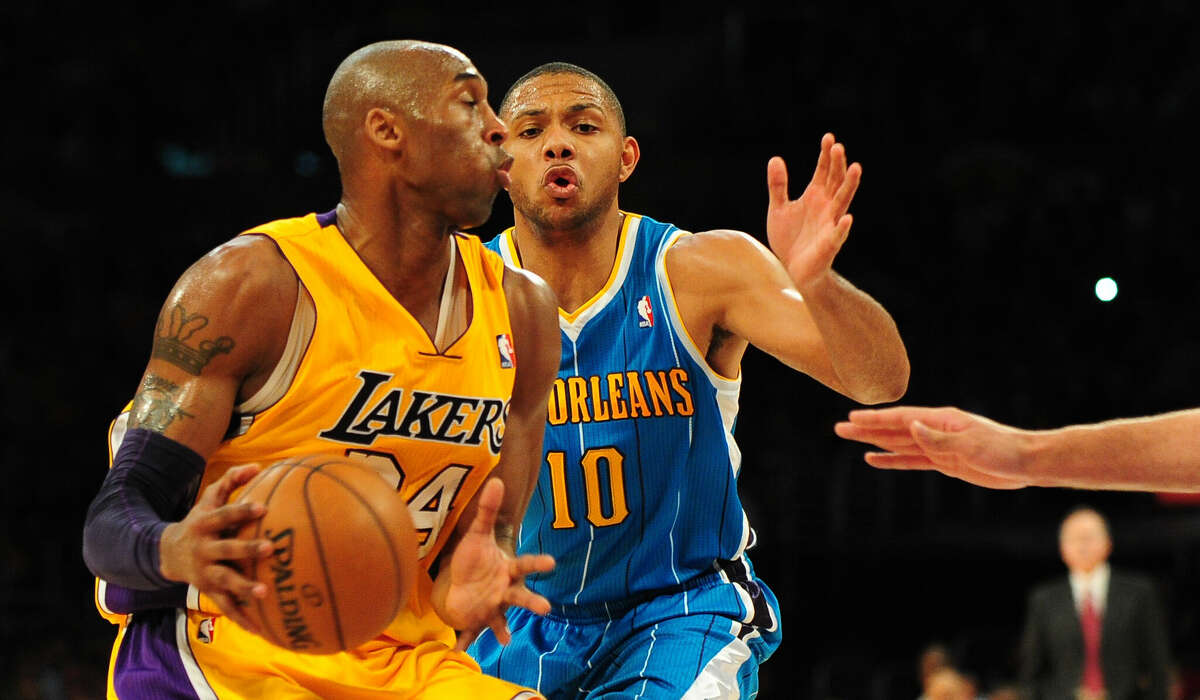 Kobe Bryant (L) of the Los Angeles Lakers attempts to navigate before Eric Gordon (R) of the New Orleans Hornets during their NBA game on January 29, 2013 at Staples Center in Los Angeles, California.