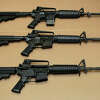 FILE -Three variations of the AR-15 assault rifle are displayed at the California Department of Justice in Sacramento, Calif., on Aug. 15, 2012. 