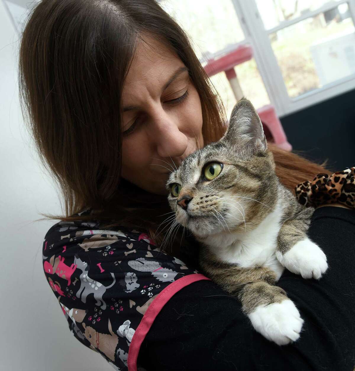 Shelter Manager Michelle DeRosa holds Sophia, who was found outside in New Haven, at Animal Haven in North Haven.