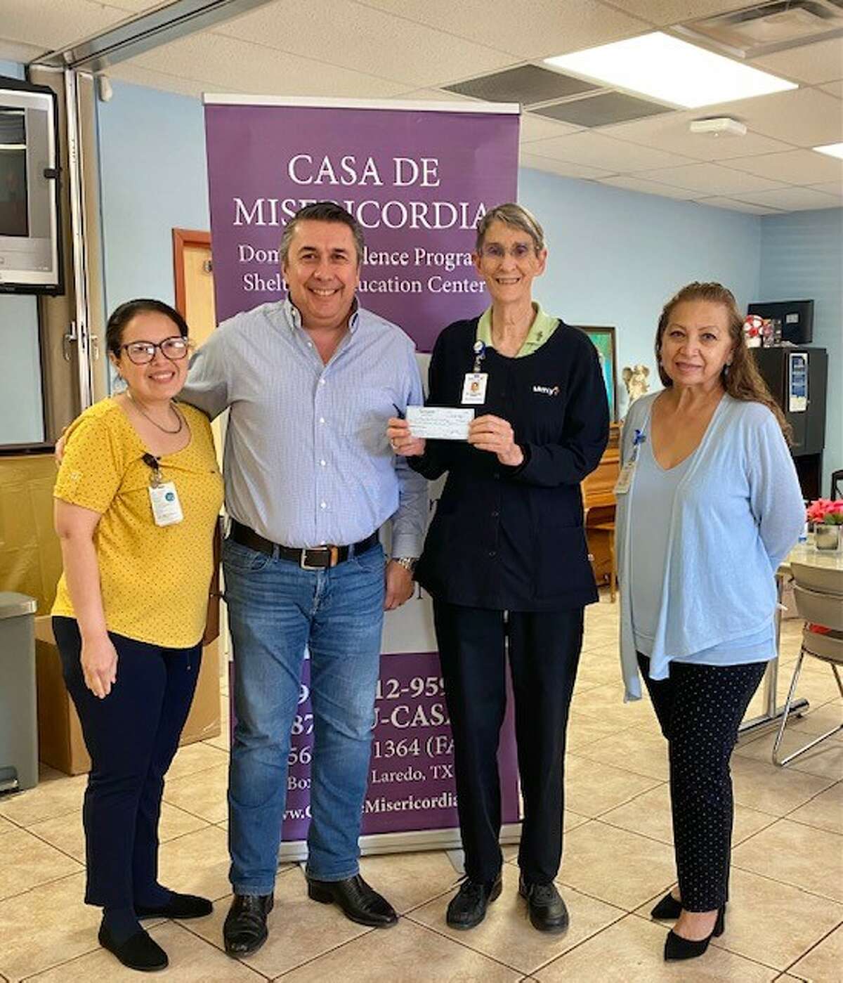 On behalf of the Casa de Misericordia domestic violence shelter in Laredo, Executive Director Sister Rosemary Welsh accepts a $4,000 donation in January from the W.R. & Floy A. Sauey Family Foundation.