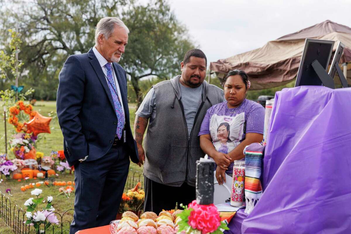 UCISD interim Superintendent Gary Patterson meets with parents of Eliahna “Ellie” Garcia, 9, at a Día de los Muertos altar at her gravesite at Hillcrest Memorial Cemetery in Uvalde on Nov. 2. Steven Garcia and Jennifer Lugo, who lost Ellie in the Robb Elementary massacre, have four other daughters.