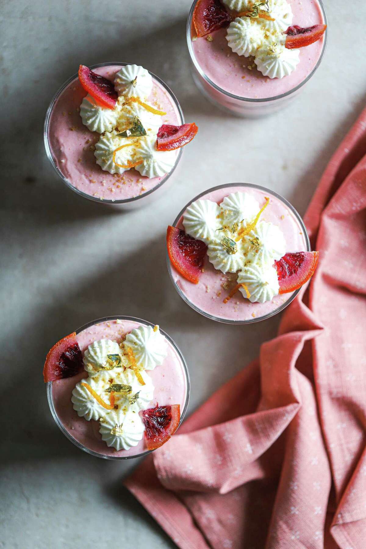 Piped whipped cream, dried slices of blood orange and zest make an attractive finish.