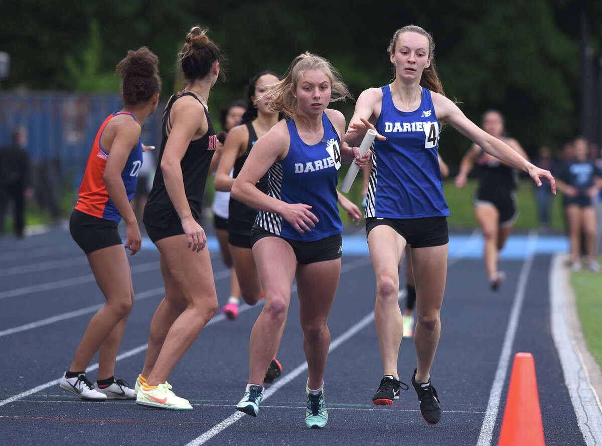 Darien's Julia Blake takes the baton from Brooke Dolan during the 4x400 relay at the FCIAC girls outdoor track and field championshipsin the spring. Blake won two events at the FCIAC ondoot meet last Thursday, winning the 1,000-meter run and as part of the 4x400 relay.