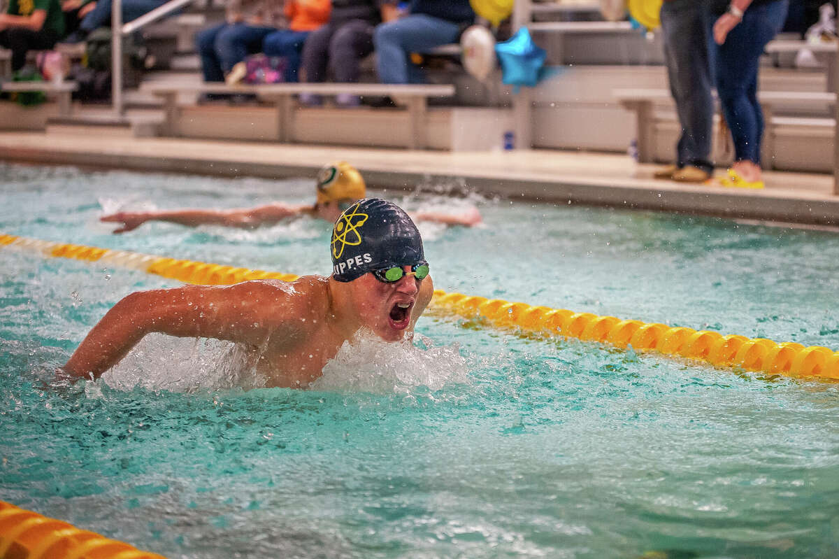 Midland High's Alexei Suppes competes in the 100 butterfly during Wednesday's meet against Dow High, Feb. 7, 2023.