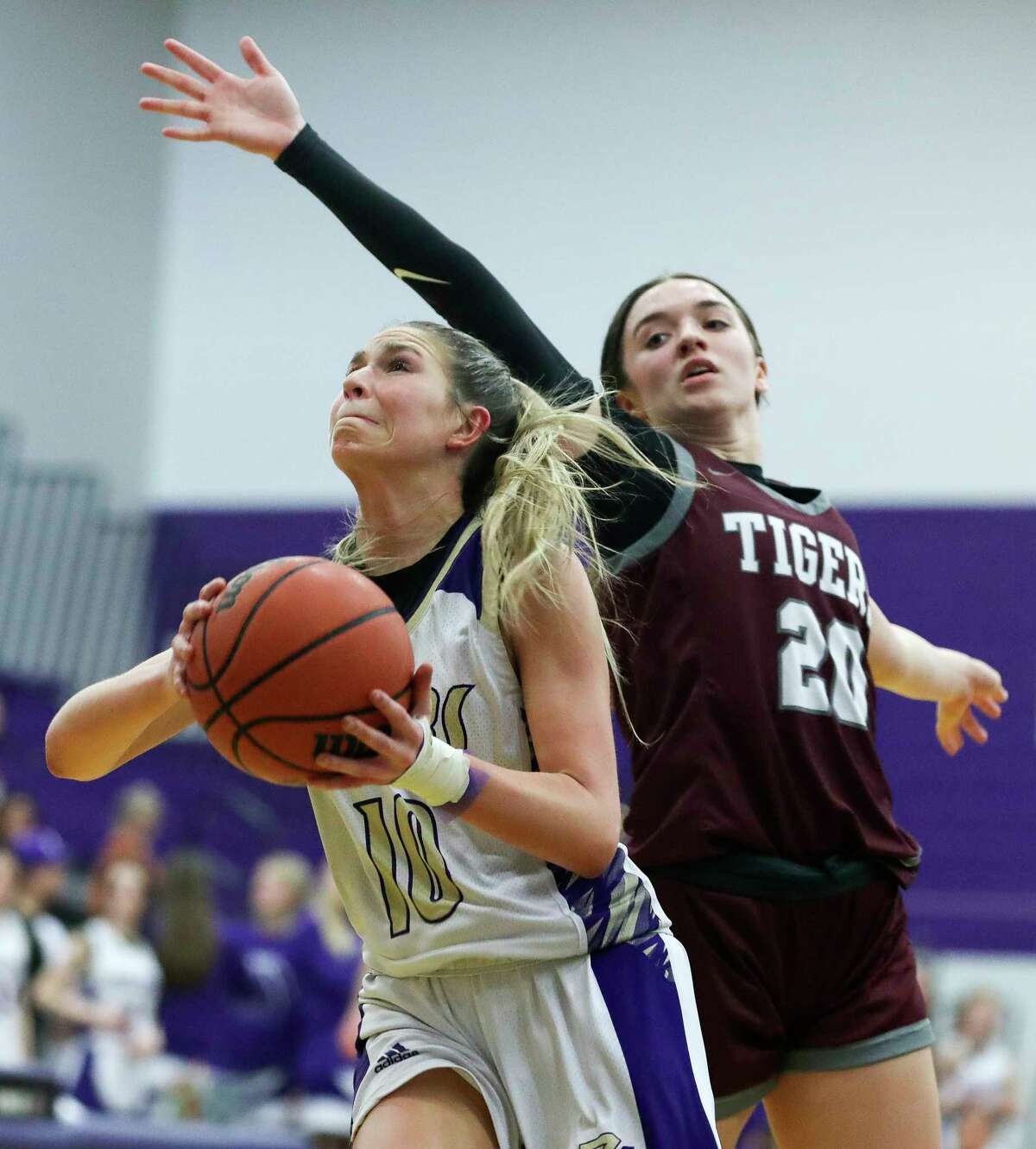 Montgomery's Savannah Piro (10) shoots under A&M Consolidated's Mia Teran (20) during the second quarter of a District 21-5A high school basketball game at Montgomery High School, Tuesday, Feb. 7, 2023, in Montgomery.