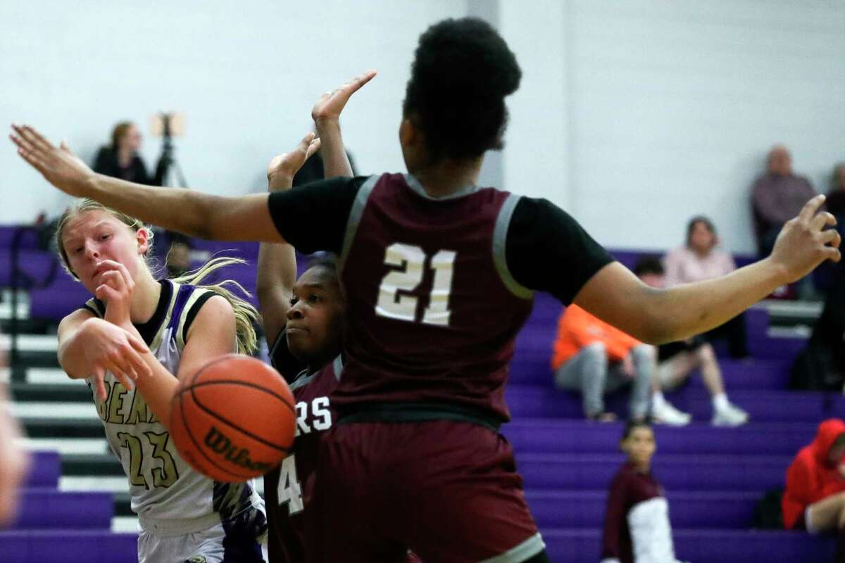 Montgomery's Kayla Zimny (23) passes around A&M Consolidated's Jayden Kearney (21) during the third quarter of a District 21-5A high school basketball game at Montgomery High School, Tuesday, Feb. 7, 2023, in Montgomery.