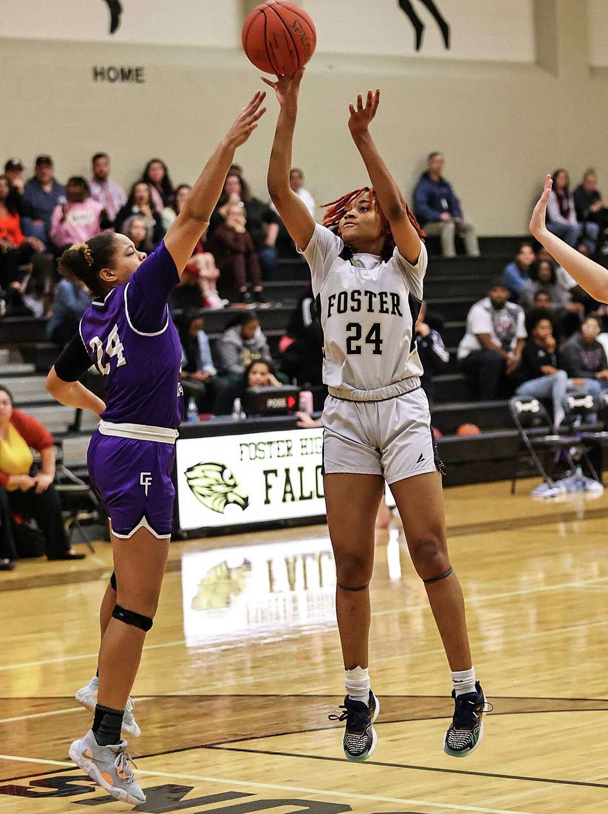 RICHMOND, TX -FEBRUARY 7: Foster Falcons Laurelle Ihekona (24) shoots from the outside as Fulshear Chargers Kimora Lopez (24) defends during a District 20-5A girls basketball game at Foster High School February 7, 2023 in Richmond,Texas.
