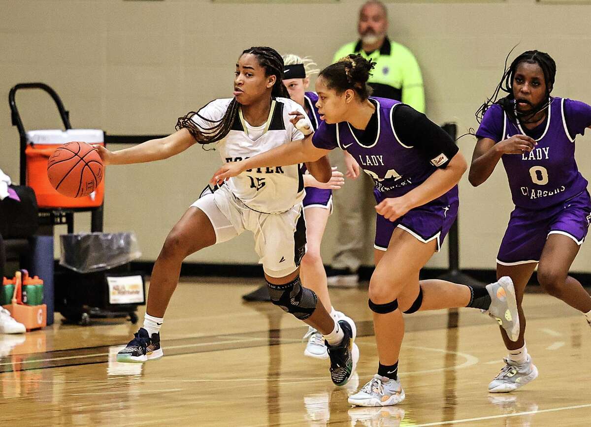 RICHMOND, TX -FEBRUARY 7: Foster Falcons Nichole Thomas (15) rushes the ball up court as Fulshear Chargers Kimora Lopez (24) and Ruke Ogbevire (0) applies pressure during a District 20-5A girls basketball game at Foster High School February 7, 2023 in Richmond,Texas.
