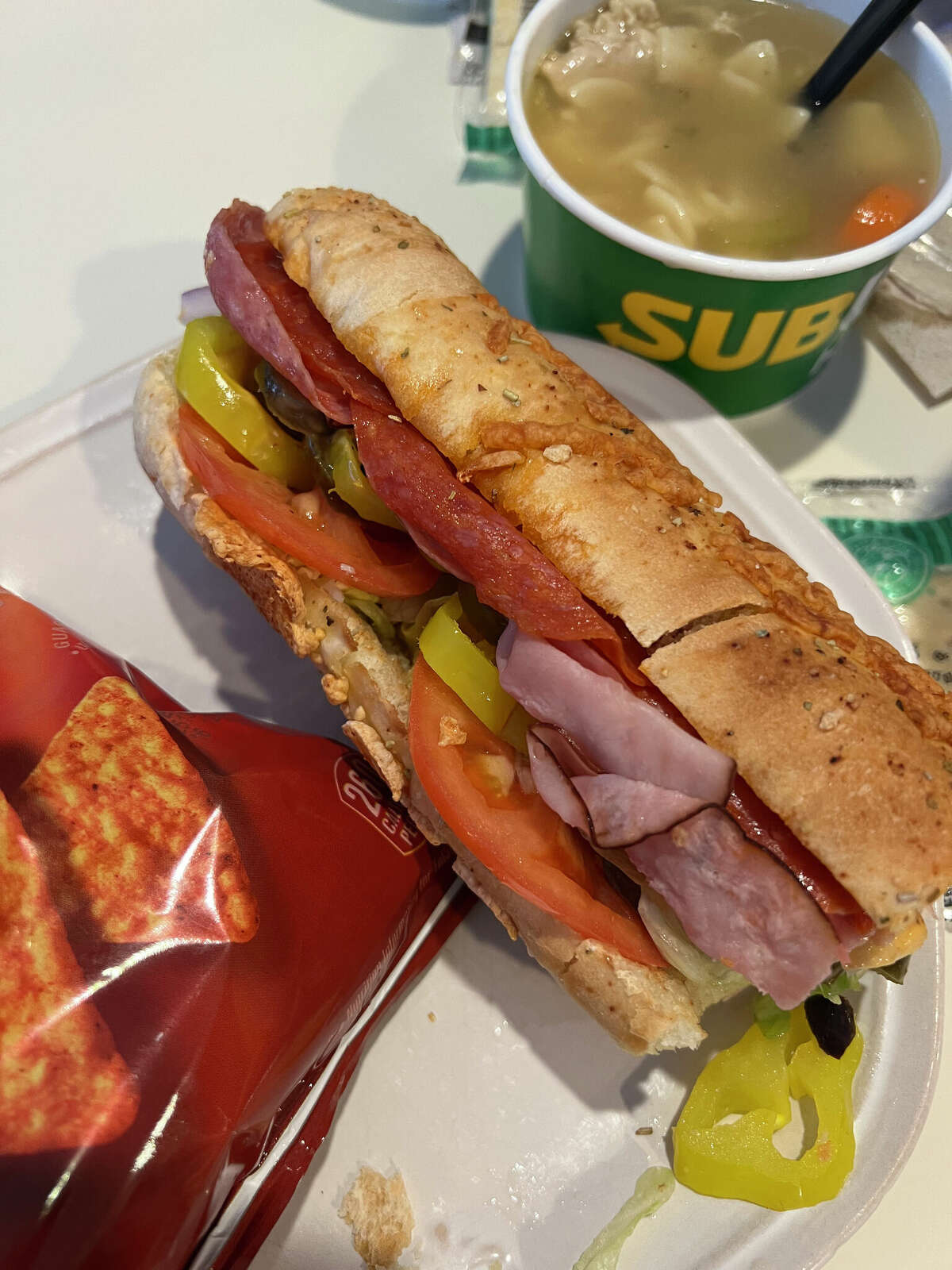 My go-to sub sandwich is Subway's Italian B.M.T., heated. This sandwich is an all-time Italian classic filled with Genoa salami, spicy pepperoni and Black Forest Ham. Then of course you choose your cheese, vegetables and condiments, served on freshly baked bread. For my Italian B.M.T., I chose the Italian Herb and Cheese bread, pepper jack cheese, lettuce, a couple slices of tomato, red onion, black olives, jalapenos and banana peppers. I also ordered Subway's chicken noodle soup and a bag of chips on the side.  