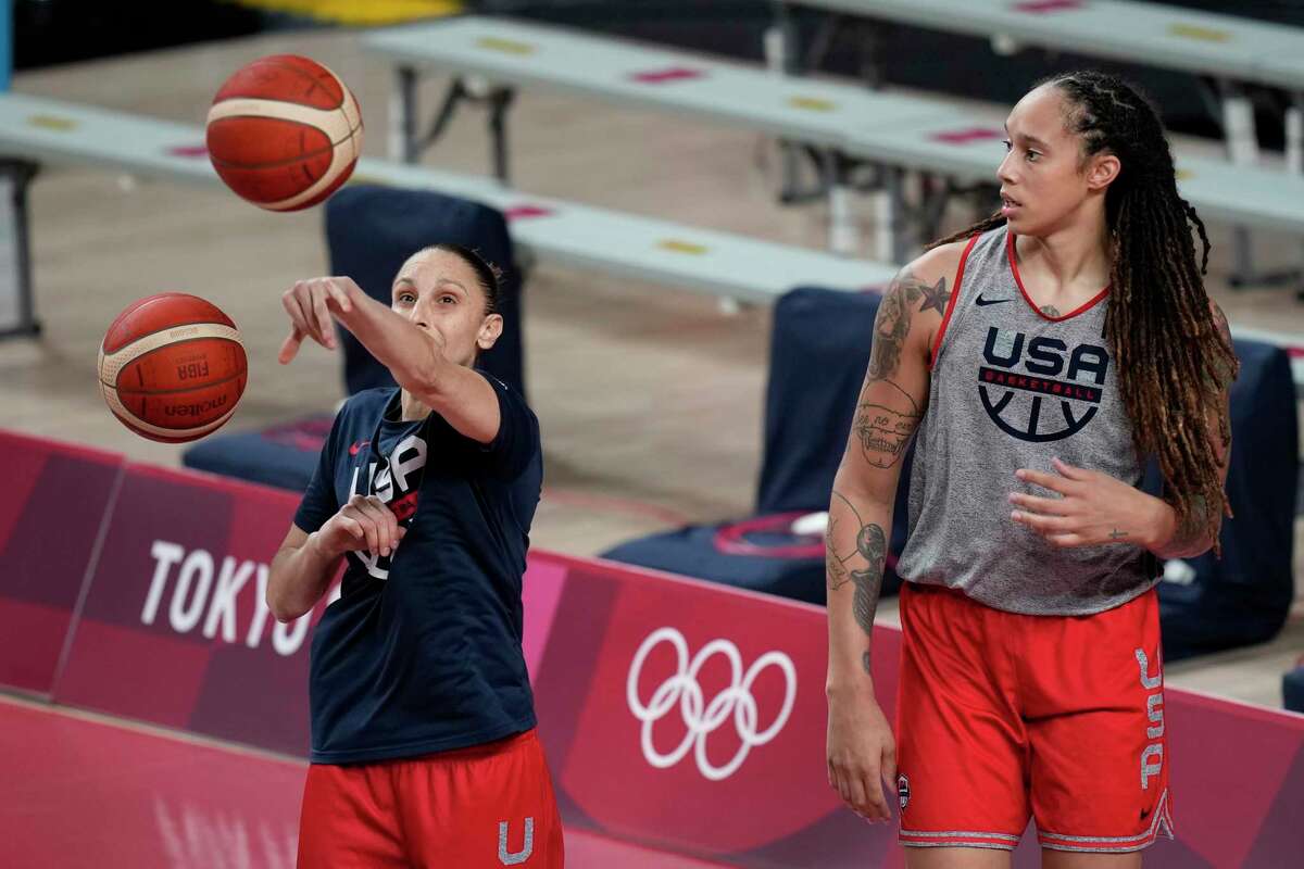 FILE - United States' Diana Taurasi, left, and Brittney Griner tale part in a women's basketball practice at the 2020 Summer Olympics, July 24, 2021, in Saitama, Japan. Taurasi’s USA Basketball career isn’t done just yet. The five-time Olympic gold medalist is part of the national team training camp in Minnesota next month. While Taurasi will be at the camp, Brittney Griner won’t. She is still part of the pool that the 2024 Olympic team will be chosen from.