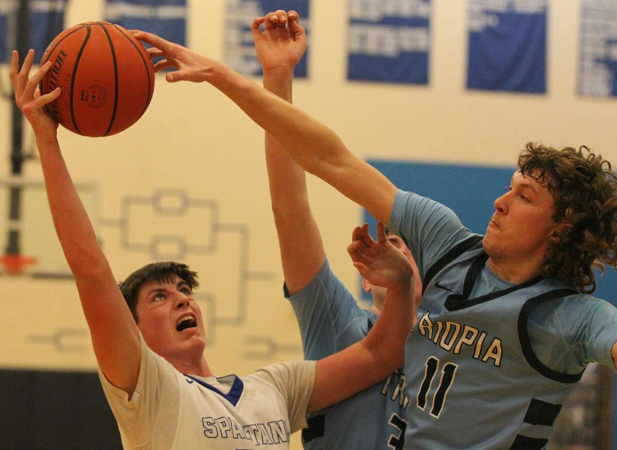 Triopia's Aiden Neathery blocks a shot during a boys' basketball game against North Greene at White Hall Tuesday night.
