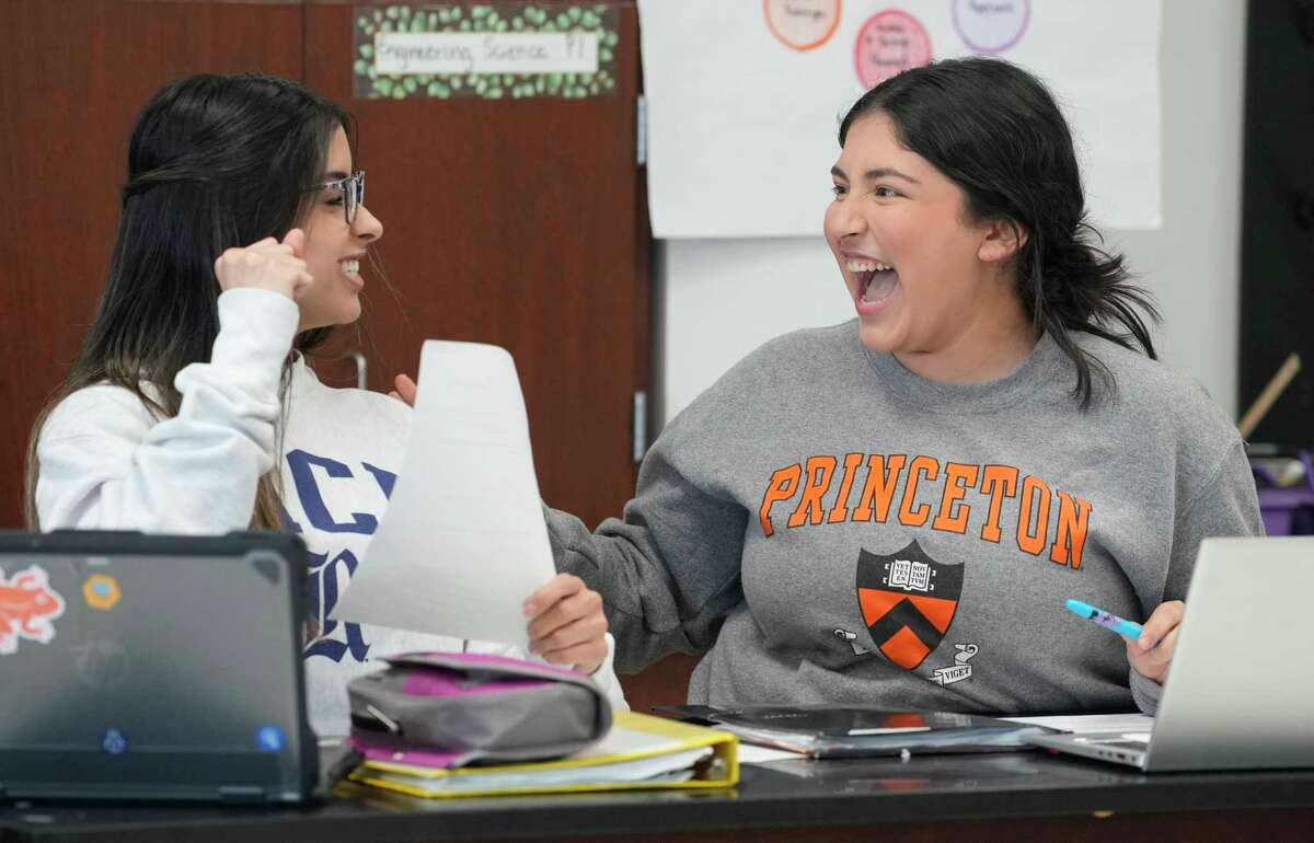 Naylie Leal, 17, left, and Angela Hernandez, 17, both seniors, prepare for a debate in their AP Macroeconomics class project at Young Women's College Prep, 1906 Cleburne St., Wednesday, Feb. 8, 2023, in Houston.