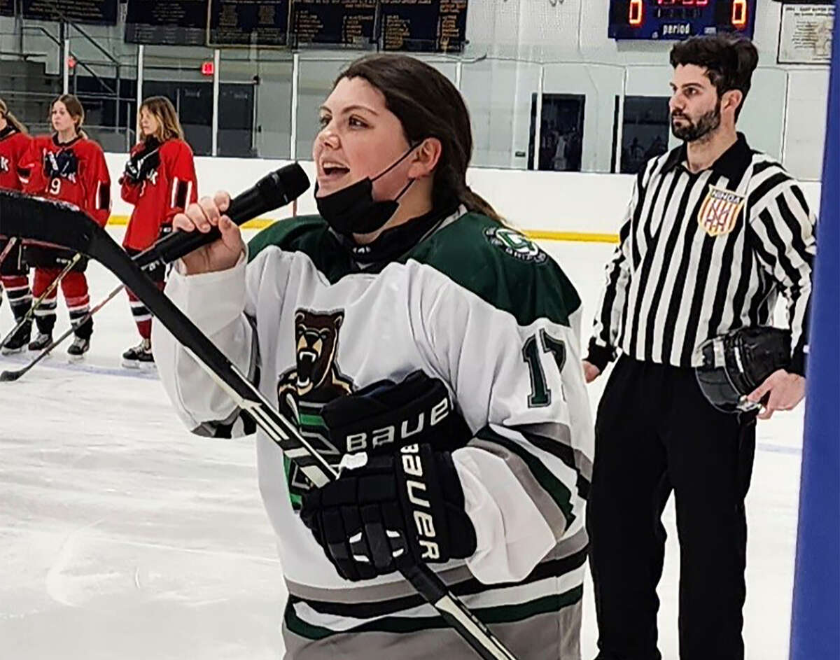 North Branford's Aislin Aiken of the Guilford co-op girls ice hockey team sings the national anthem before the start of a game against the Masuk co-op on Saturday, Feb. 4, 2023.