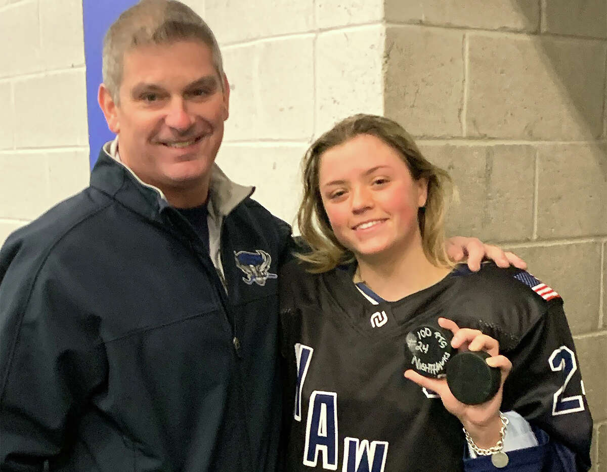 Wethersfield's Nicole Partridge of the Southington/Avon co-op girls ice hockey team with coach Mike Carrera after Partridge surpassed 100 career points with three assists in a win over Fairfield in Newington on Friday, Feb. 3, 2023.