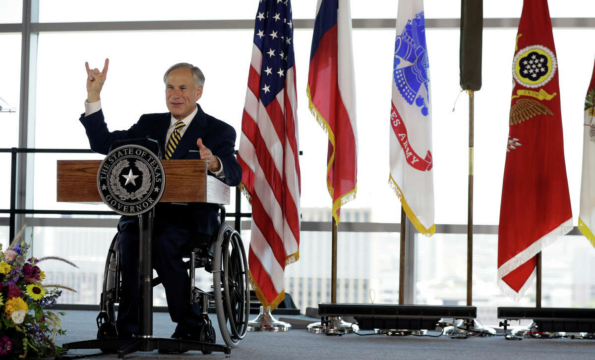 Texas Gov. Greg Abbott gives the 'Hook'em" sign during an activation ceremony for the U.S. Army futures Command, Friday, Aug. 24, 2018, in Austin, Texas. The headquarters will be located at the University of Texas Systems Building in Austin. 