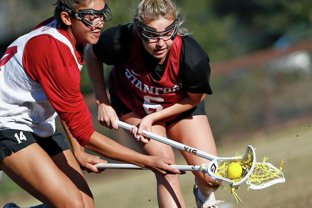 From left: Grace Turner (14) and Ashley Humphrey (6) during Stanford Cardinal women’s lacrosse practice at Ueland Field in Stanford, Calif., Tuesday, Jan. 31, 2023.