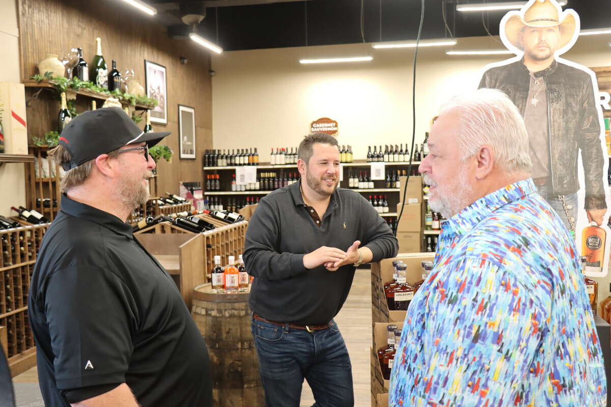 Longhorn Liquor general manager Michael Wright, left, co-owner Mike Williams, middle, and co-owner Dennis Williams, right, discuss business matters on Tuesday, Feb. 7, 2023, at the store's Beaumont location on Dowlen Road.