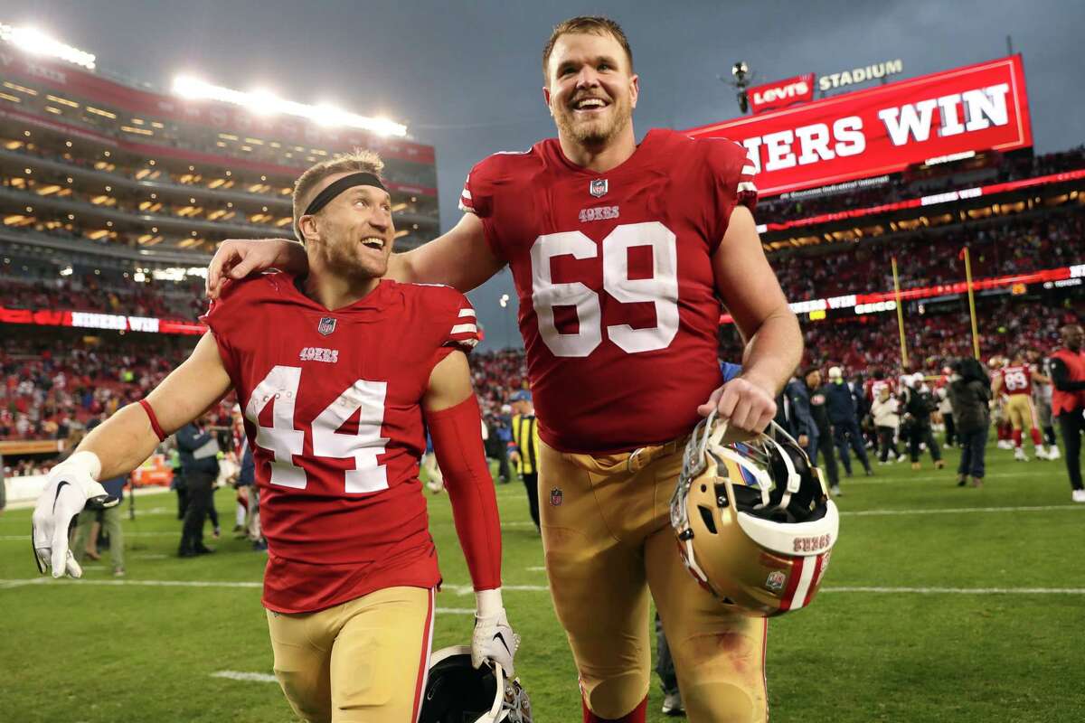 San Francisco 49ers’ Mike McGlinchey and Kyle Juszczyk celebrate after Niners’ 41-23 win over Seattle Seahawks in NFC Wild Card Playoffs in Santa Clara, Calif., on Saturday, January 14, 2023.