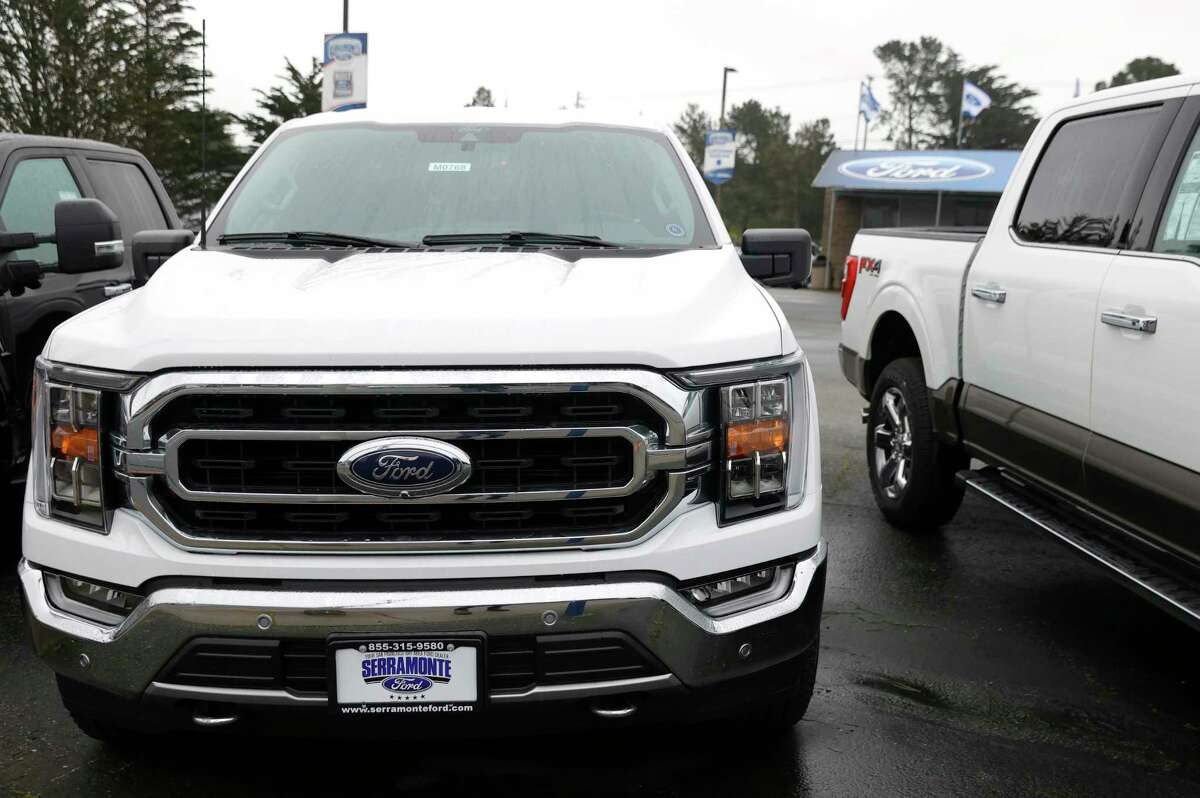 Brand new Ford trucks are displayed on the sales lot at Serramonte Ford in Colma, Calif., in 2022. A state lawmaker wants to explore charging drivers more in registration fees for owning heavier vehicles such as trucks or SUVs.