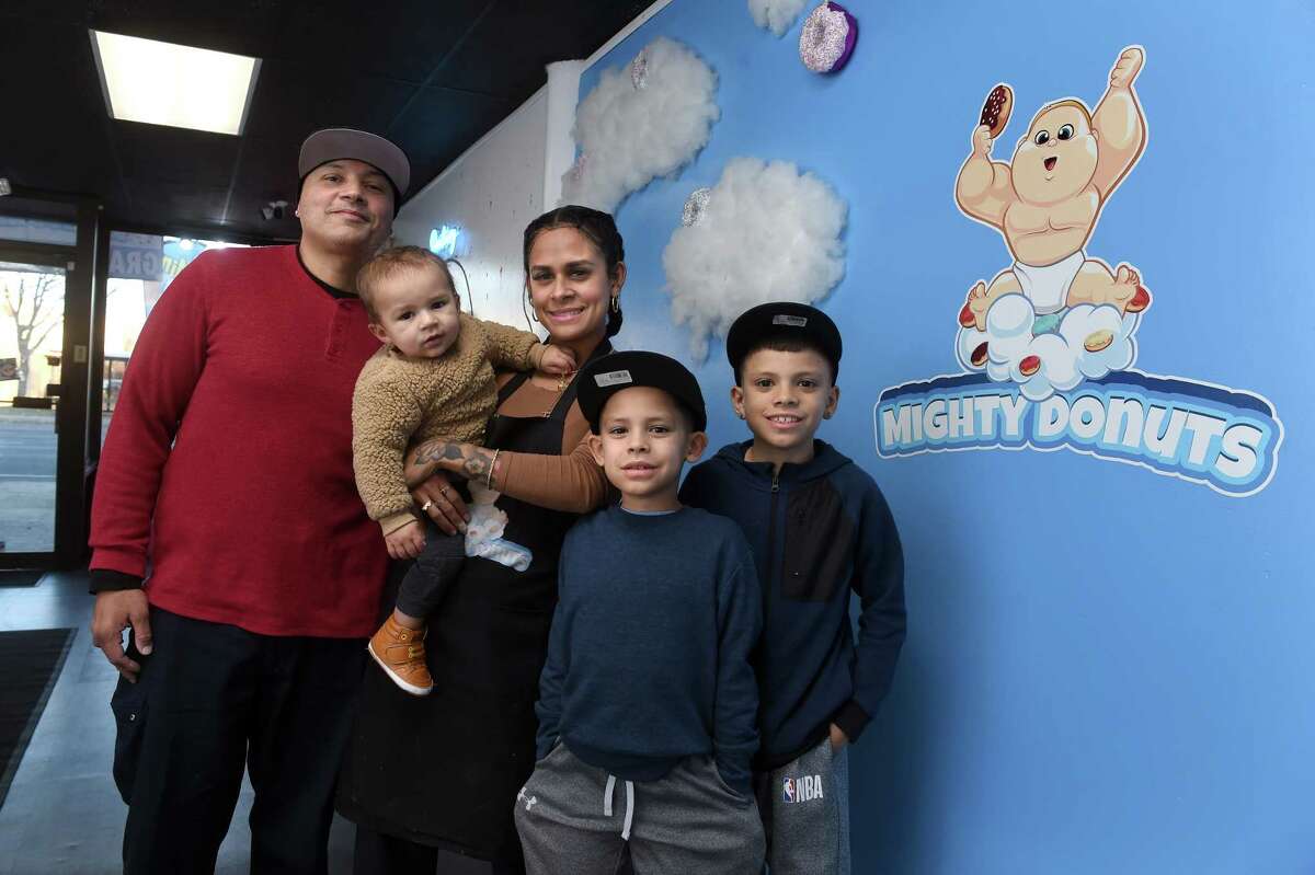The Estrada family, from left, Luis, Gvan, 10 months, Yericka, Geo, 8, and Gian, 11, photographed at the family business, Mighty Donuts, on Dixwell Avenue in Hamden Wednesday.