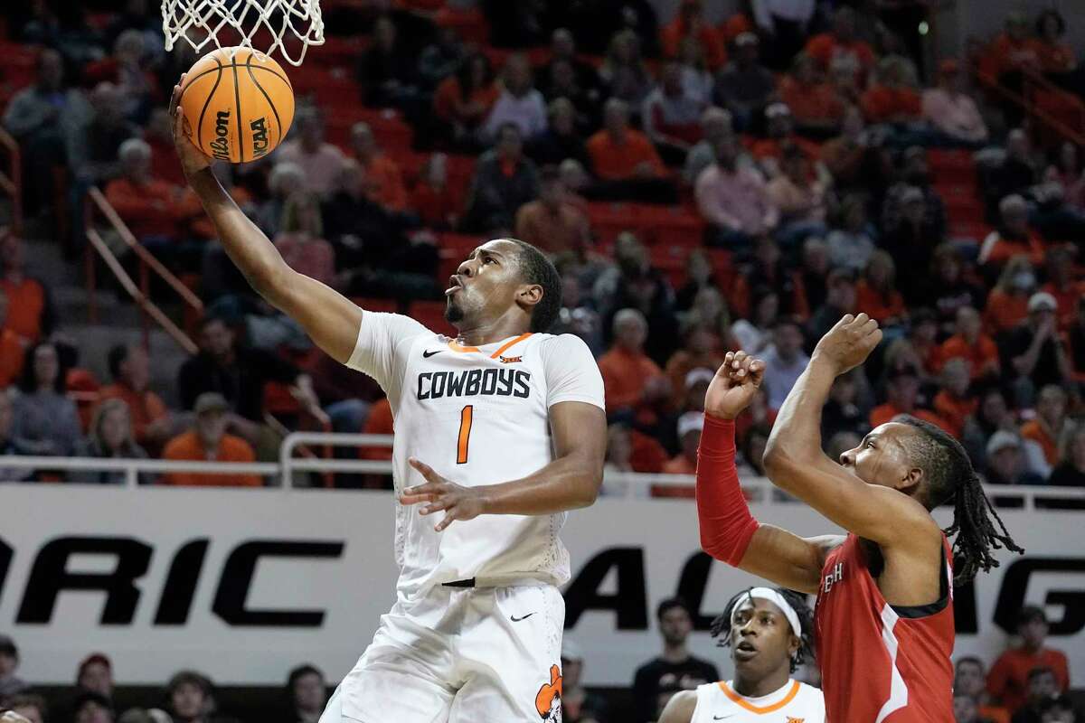 Oklahoma State guard Bryce Thompson (1) goes to the basket in front of Texas Tech guard Lamar Washington, right, in the first half of an NCAA college basketball game Wednesday, Feb. 8, 2023, in Stillwater, Okla.