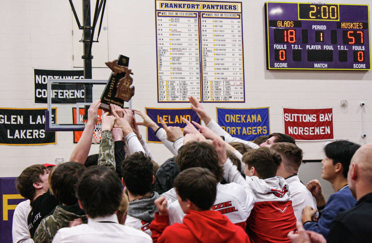 Benzie Central wrestling hoists its district championship trophy on Feb. 8, 2023 at Frankfort High School. 