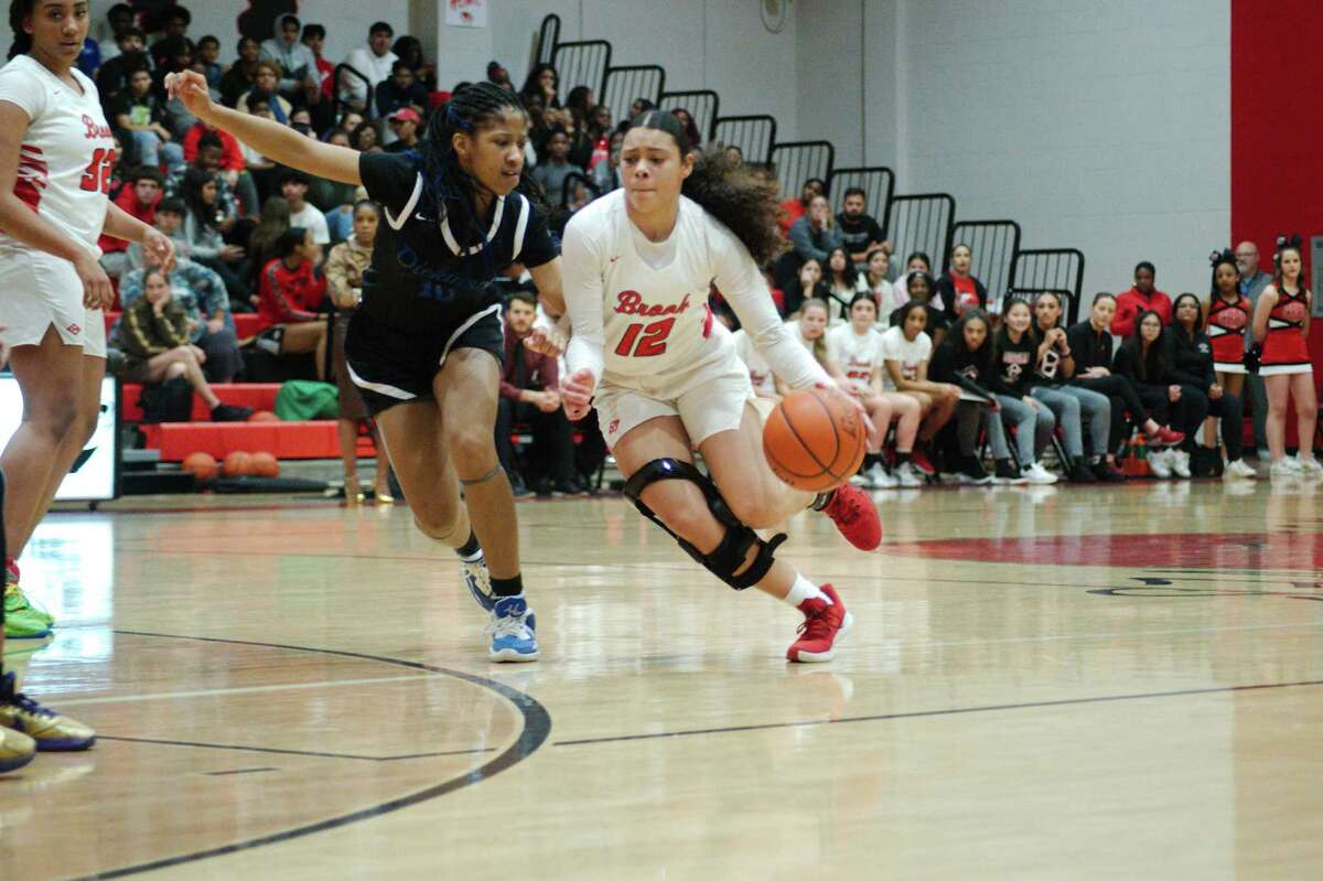 Clear Brook’s Ja'Delle Major (12) dribbles past Dickinson’s Tariyah Ford (10) Wednesday, Feb. 8, 2023 at Clear Brook High chool.