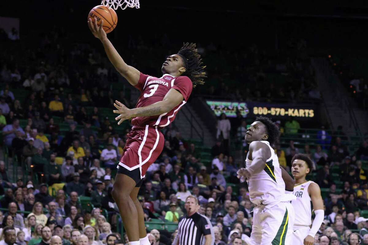 Oklahoma guard Otega Oweh (3) scores past Baylor forward Jonathan Tchamwa Tchatchoua (23) during the first half of an NCAA college basketball game Wednesday, Feb. 8, 2023, in Waco, Texas.